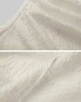 DOINDULGE Textured Knit Asymmetric Buttoned Long Sleeve Top