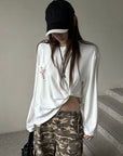 Rase le sol Amor Fati Cross-Embroidered Asymmetric Draped Long Sleeve Top