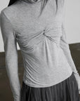 DOINDULGE Draped Twist Knit Top with High Neck and Long Sleeves