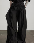 DOINDULGE Wide-Leg Draped Pants with Fringed Panels and Deconstructed Details