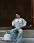 ROVENTE Draped Open Back Long Sleeve Top with Adjustable Strap