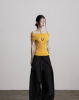 DOINDULGE Off-Shoulder Ribbed Knit Top with Wooden Medallion Detail