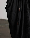 DOINDULGE Asymmetric Draped Maxi Dress with Textured Fabric and Wooden Bead Detail