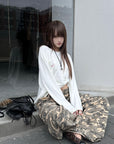 Rase le sol Amor Fati Cross-Embroidered Asymmetric Draped Long Sleeve Top