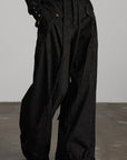 DOINDULGE Textured Wide-Leg Trousers with Draped Panels and Rope Detail