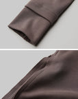 DOINDULGE Asymmetric Long Sleeve Top with Draped Hem