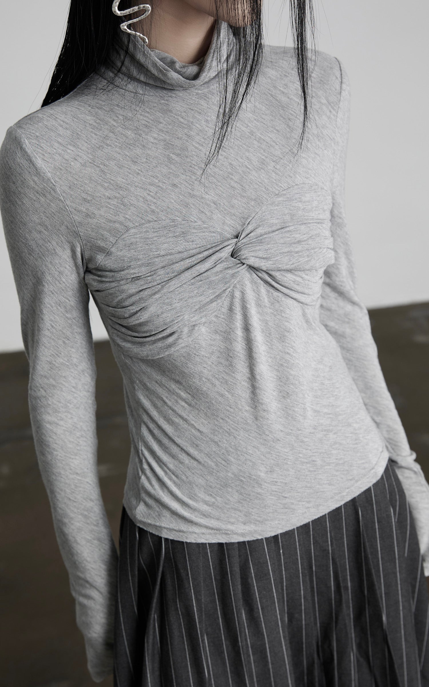 DOINDULGE Draped Twist Knit Top with High Neck and Long Sleeves