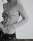 DOINDULGE Draped Twist Knit Top with High Neck and Long Sleeves