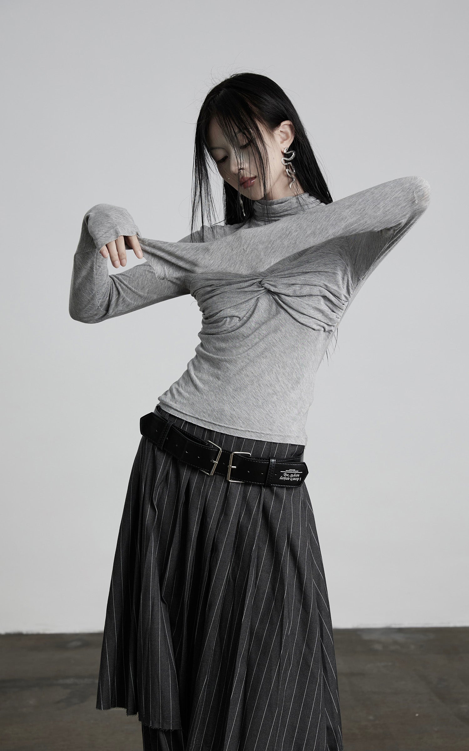 DOINDULGE Draped Twist Knit Top with High Neck and Long Sleeves