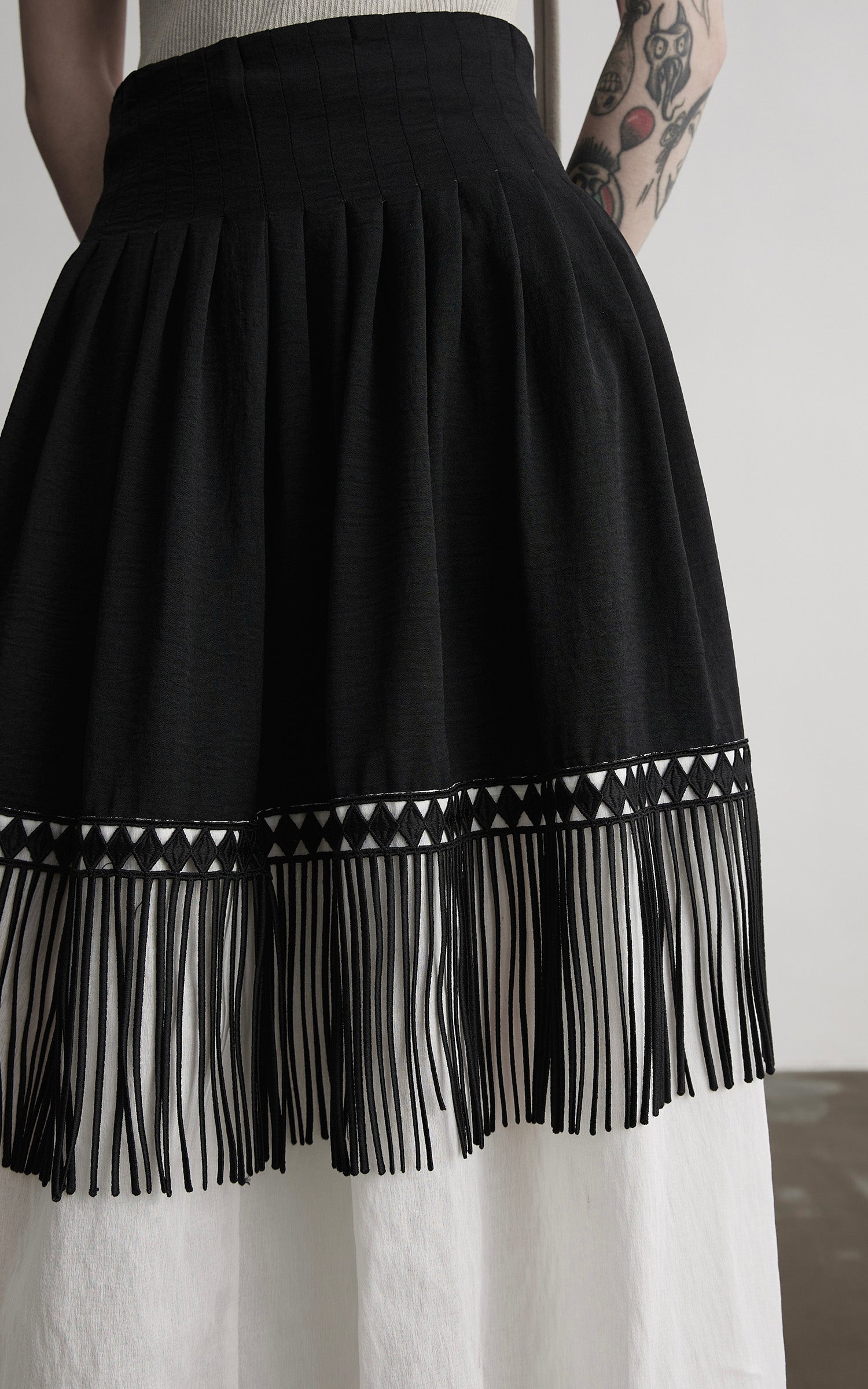 DOINDULGE Fringe Paneled Layered Skirt with Pleats and Contrast Hem