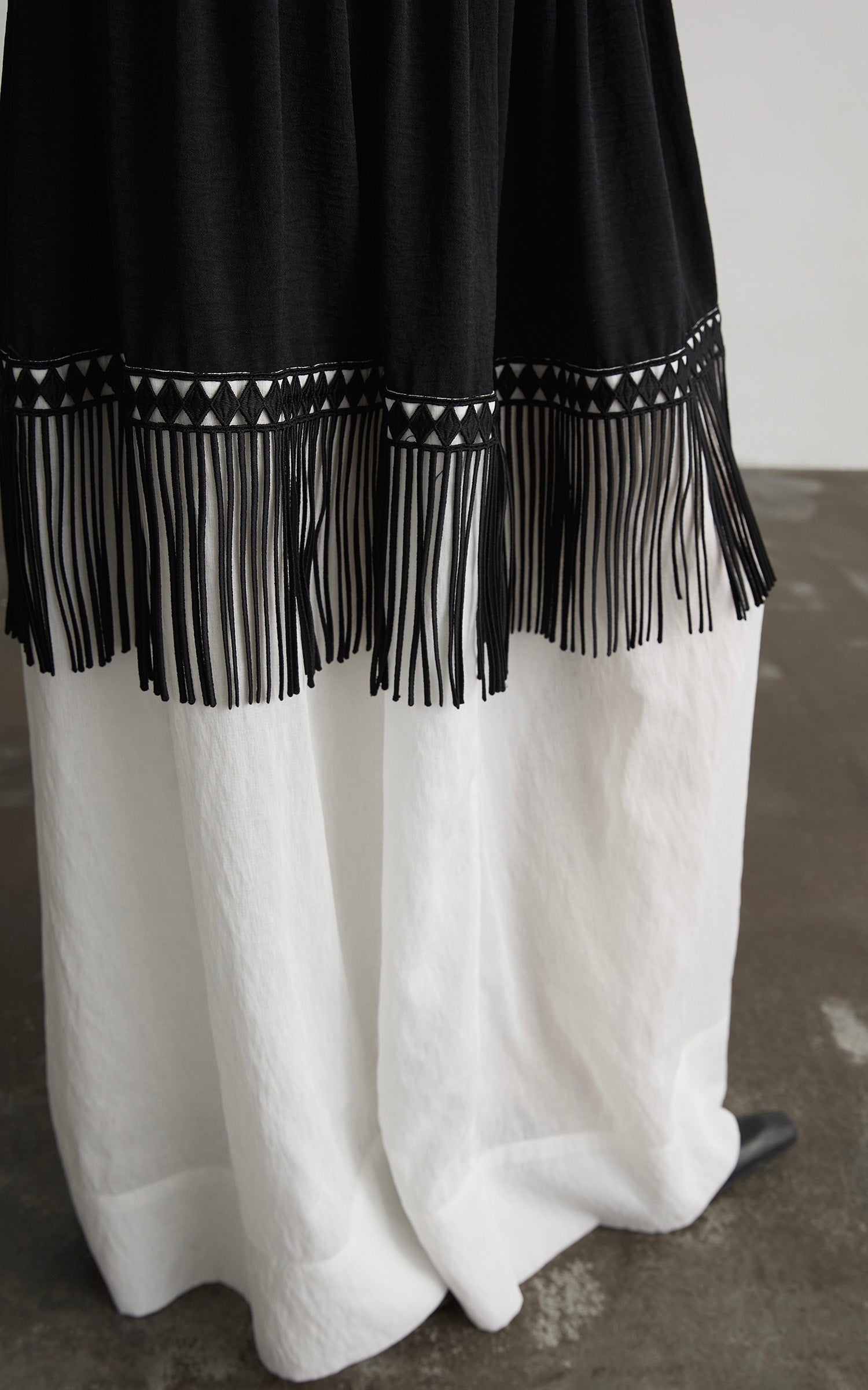 DOINDULGE Fringe Paneled Layered Skirt with Pleats and Contrast Hem