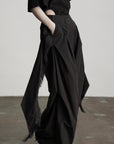 DOINDULGE Wide-Leg Draped Pants with Fringed Panels and Deconstructed Details