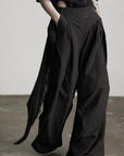 DOINDULGE Wide-Leg Draped Pants with Fringed Panels and Deconstructed Details