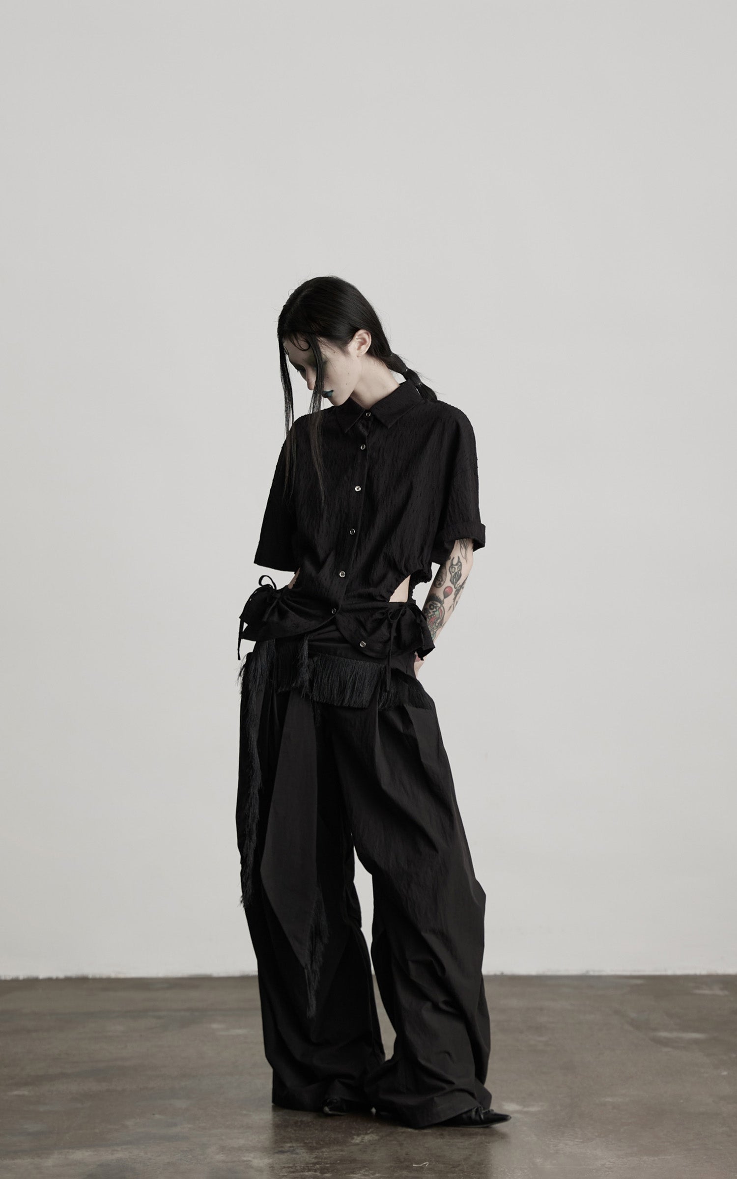 DOINDULGE Wide-Leg Draped Pants with Fringed Panels and Deconstructed Details