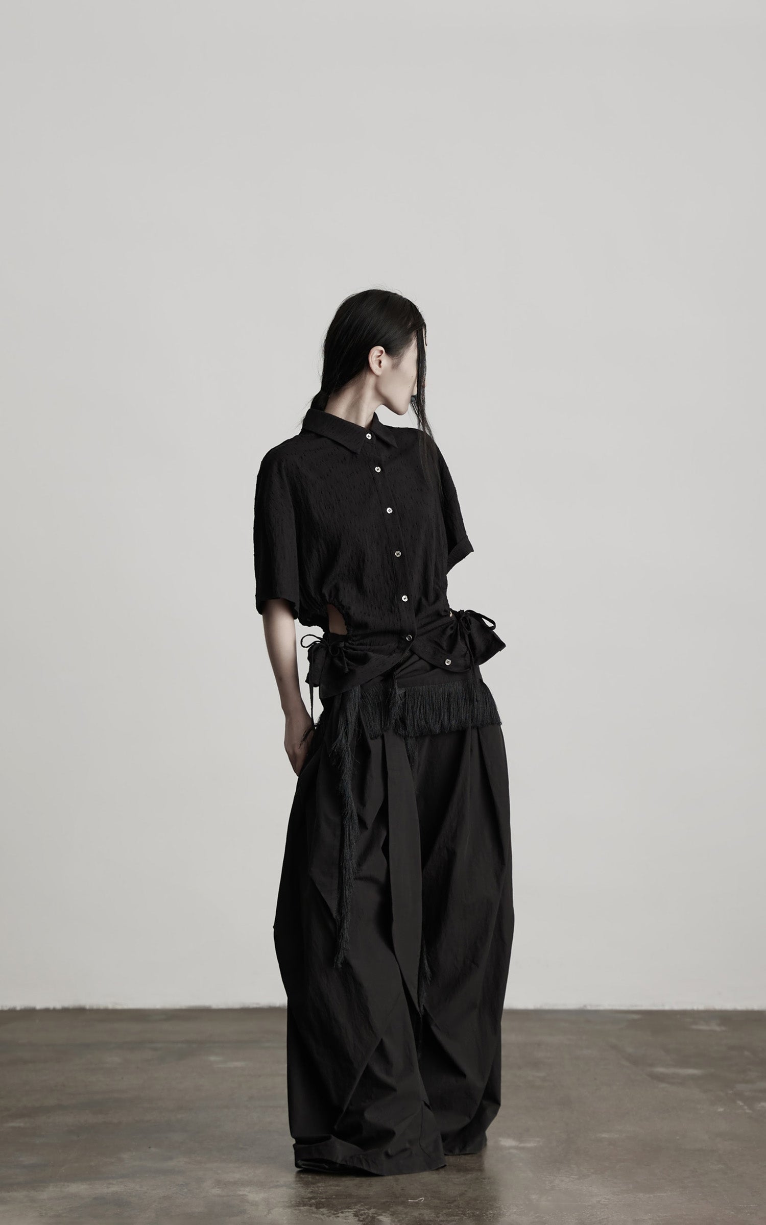 DOINDULGE Wide-Leg Draped Pants with Fringed Panels and Deconstructed Details