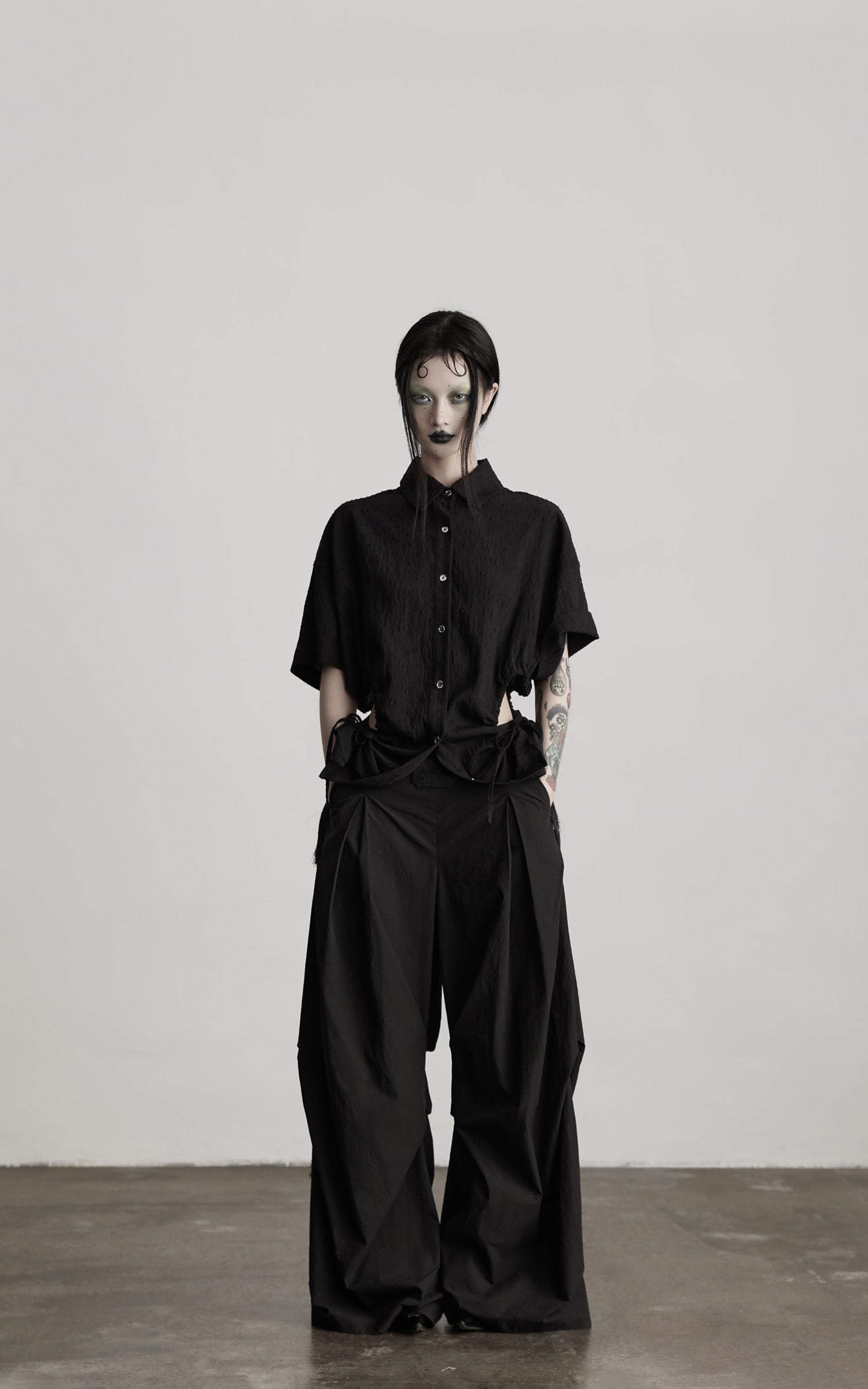 DOINDULGE Wide-Leg Draped Pants with Fringed Panels and Deconstructed Details