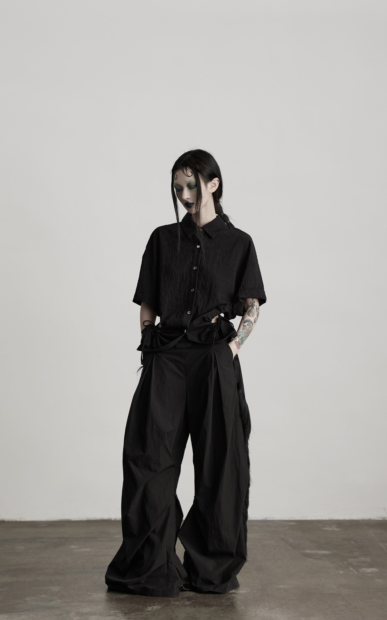 DOINDULGE Wide-Leg Draped Pants with Fringed Panels and Deconstructed Details