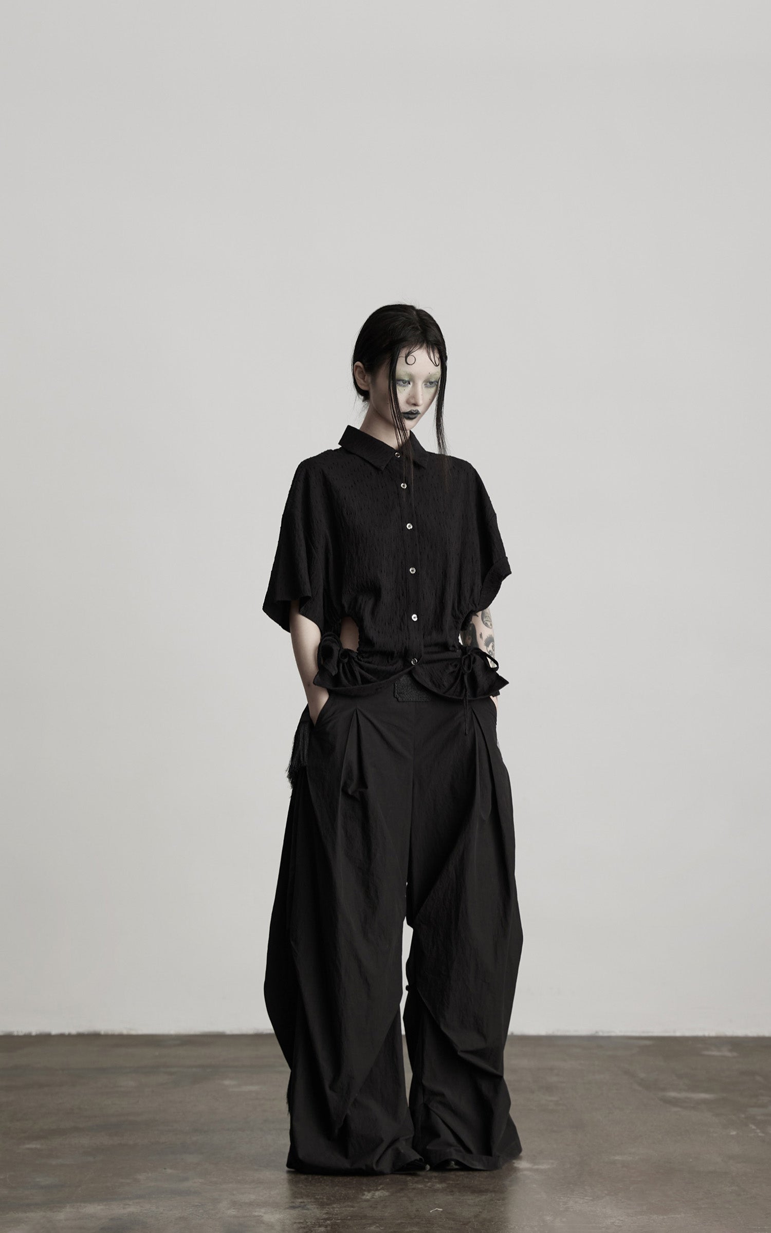 DOINDULGE Wide-Leg Draped Pants with Fringed Panels and Deconstructed Details
