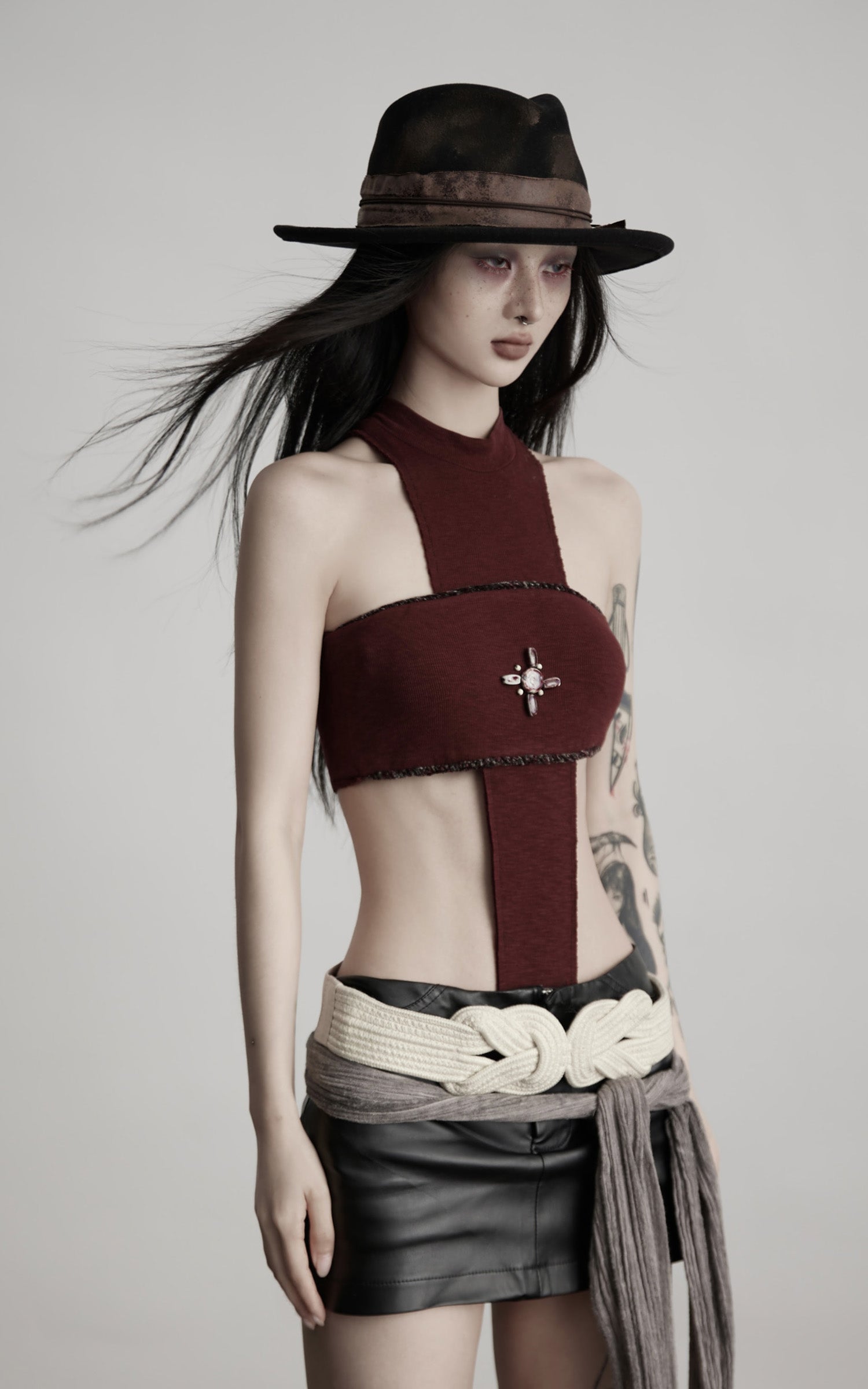 DOINDULGE Asymmetric Cutout Bodysuit with Ceramic Cross Embellishment
