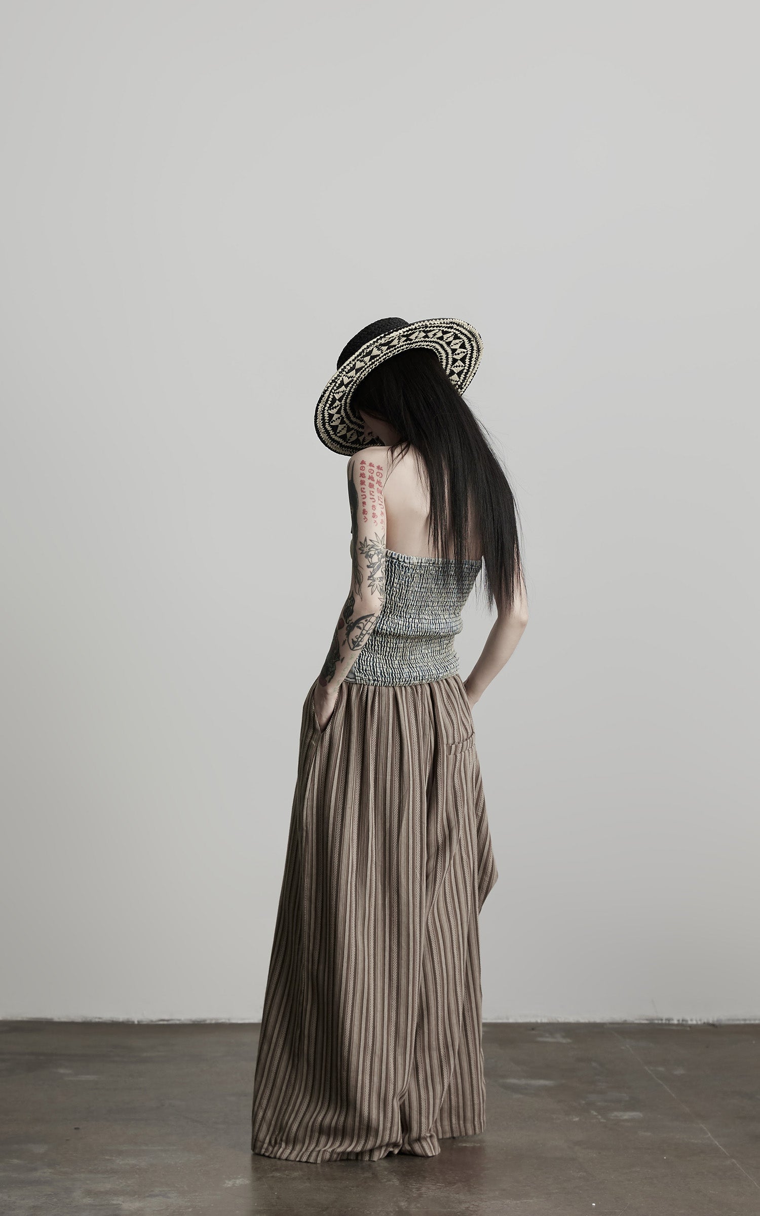 DOINDULGE Draped Asymmetric Wide-Leg Trousers in Textured Stripe