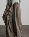 DOINDULGE Draped Asymmetric Wide-Leg Trousers in Textured Stripe