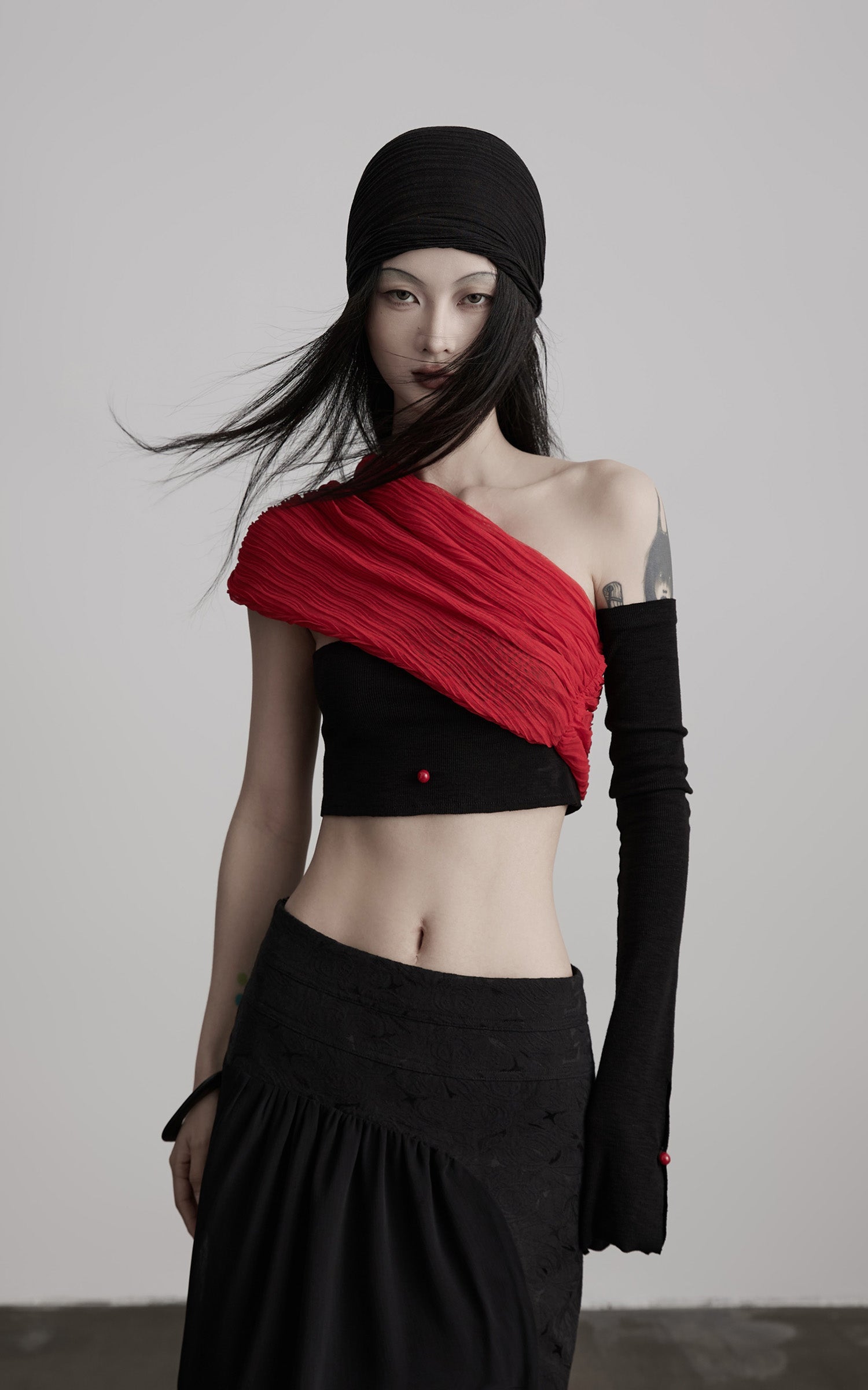 DOINDULGE Asymmetric Drape Top — Sculptural Red Pleats with Black Knit Base