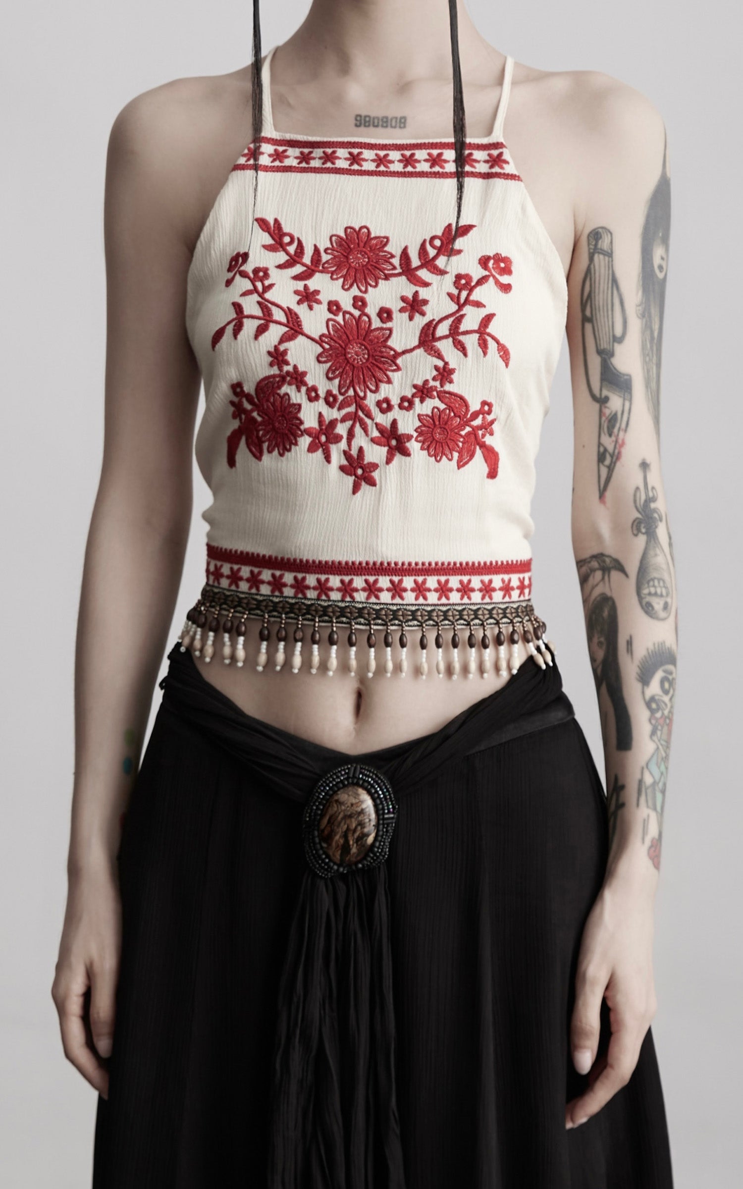 DOINDULGE Embroidered Halter Top with Floral Motif and Beaded Hem Detailing