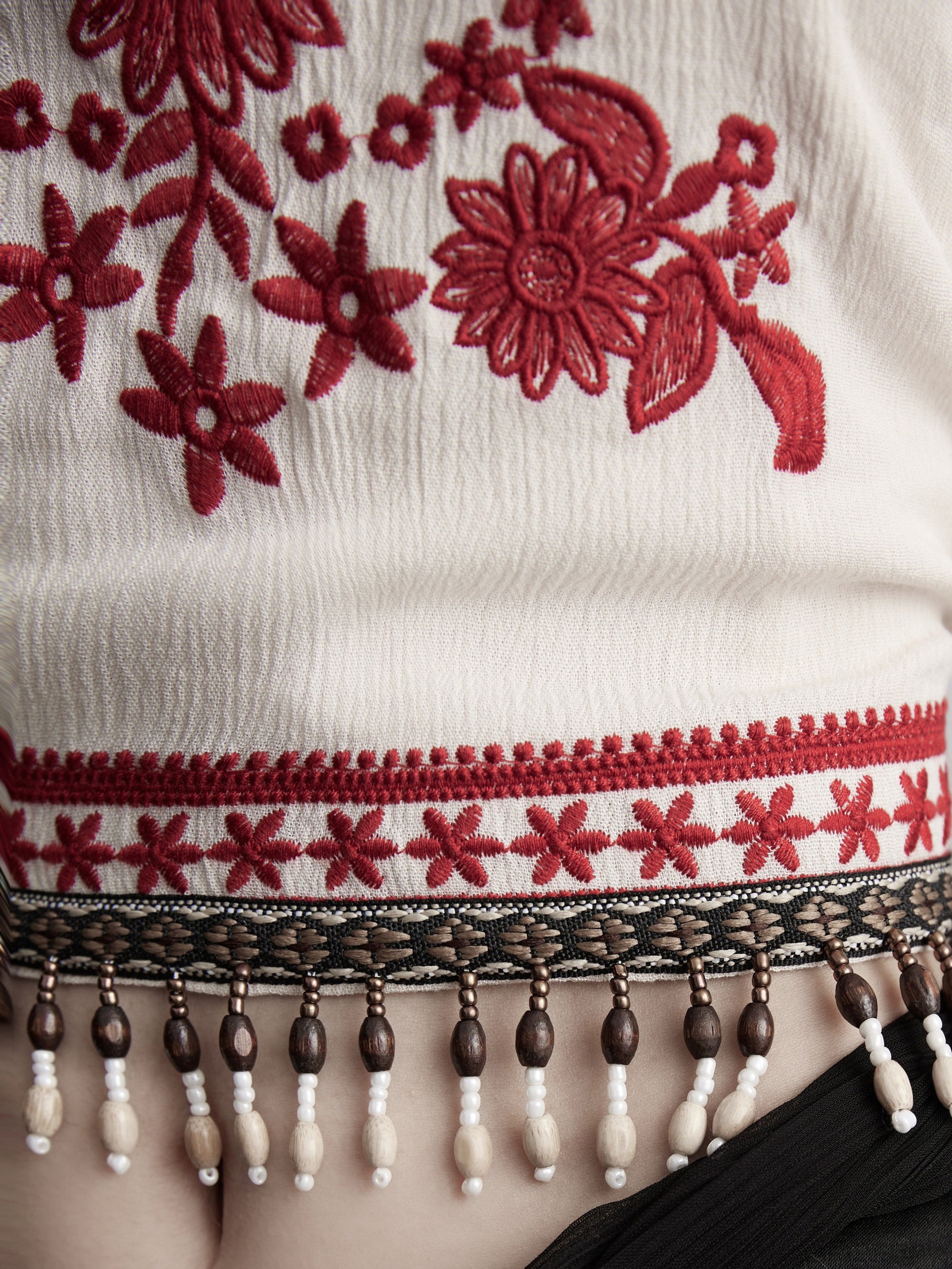 DOINDULGE Embroidered Halter Top with Floral Motif and Beaded Hem Detailing