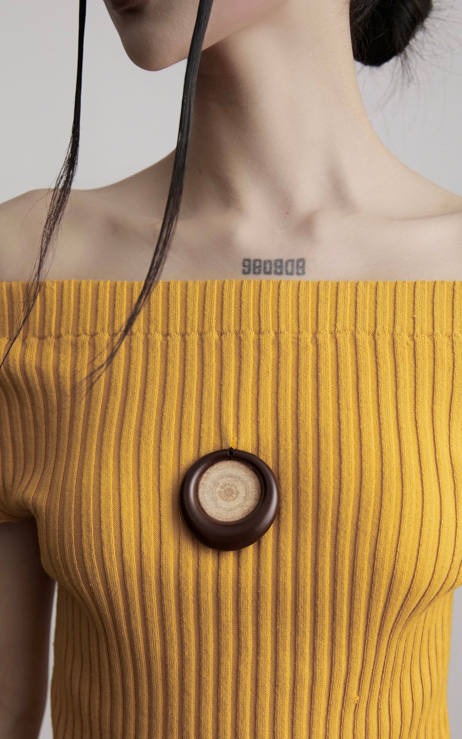 DOINDULGE Off-Shoulder Ribbed Knit Top with Wooden Medallion Detail