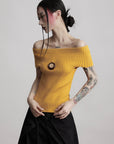DOINDULGE Off-Shoulder Ribbed Knit Top with Wooden Medallion Detail