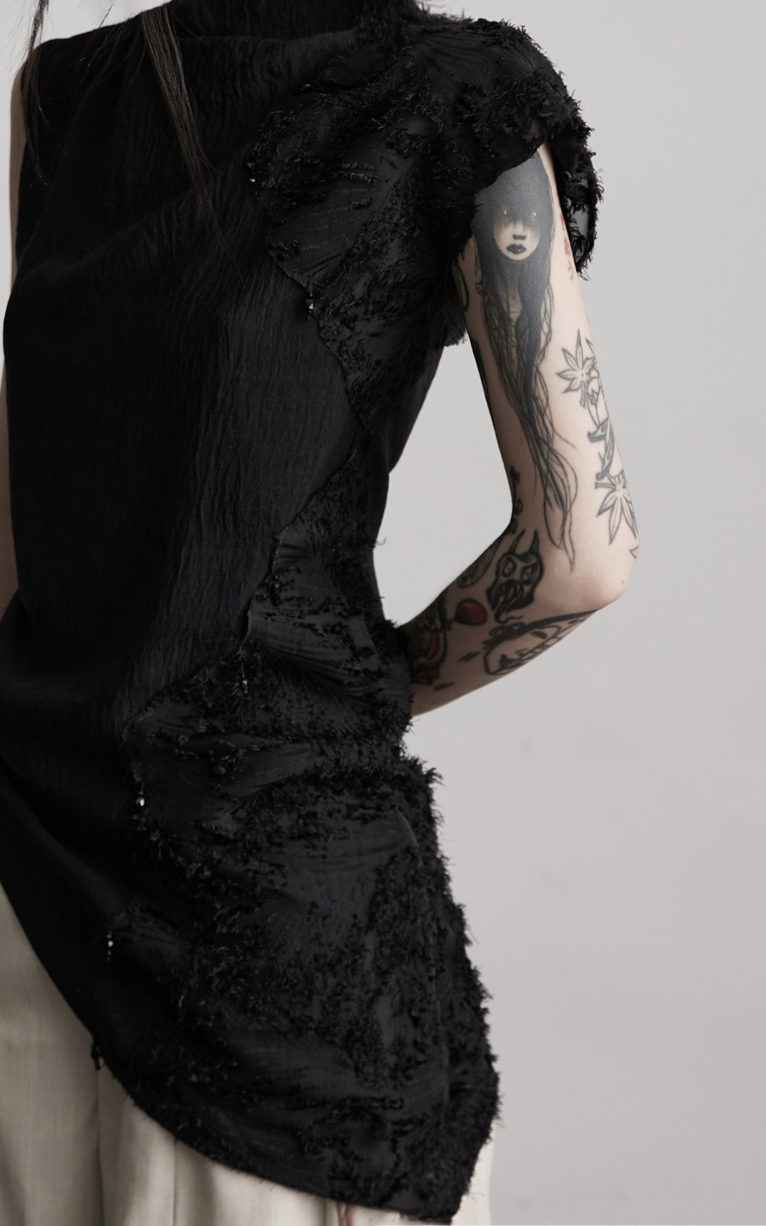 DOINDULGE Asymmetric Textured Sleeveless Top with Frayed and Beaded Detailing
