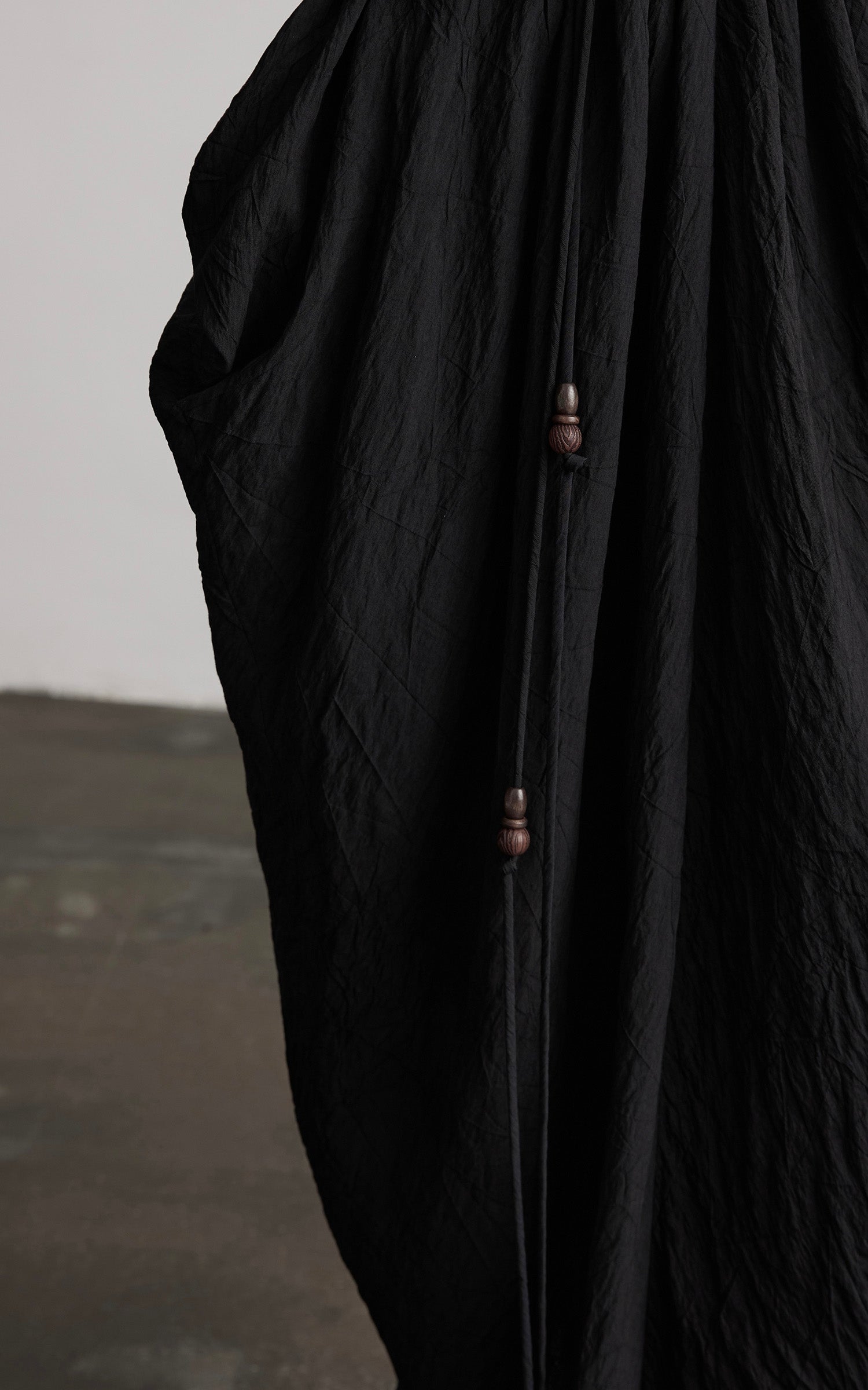 DOINDULGE Asymmetric Draped Maxi Dress with Textured Fabric and Wooden Bead Detail