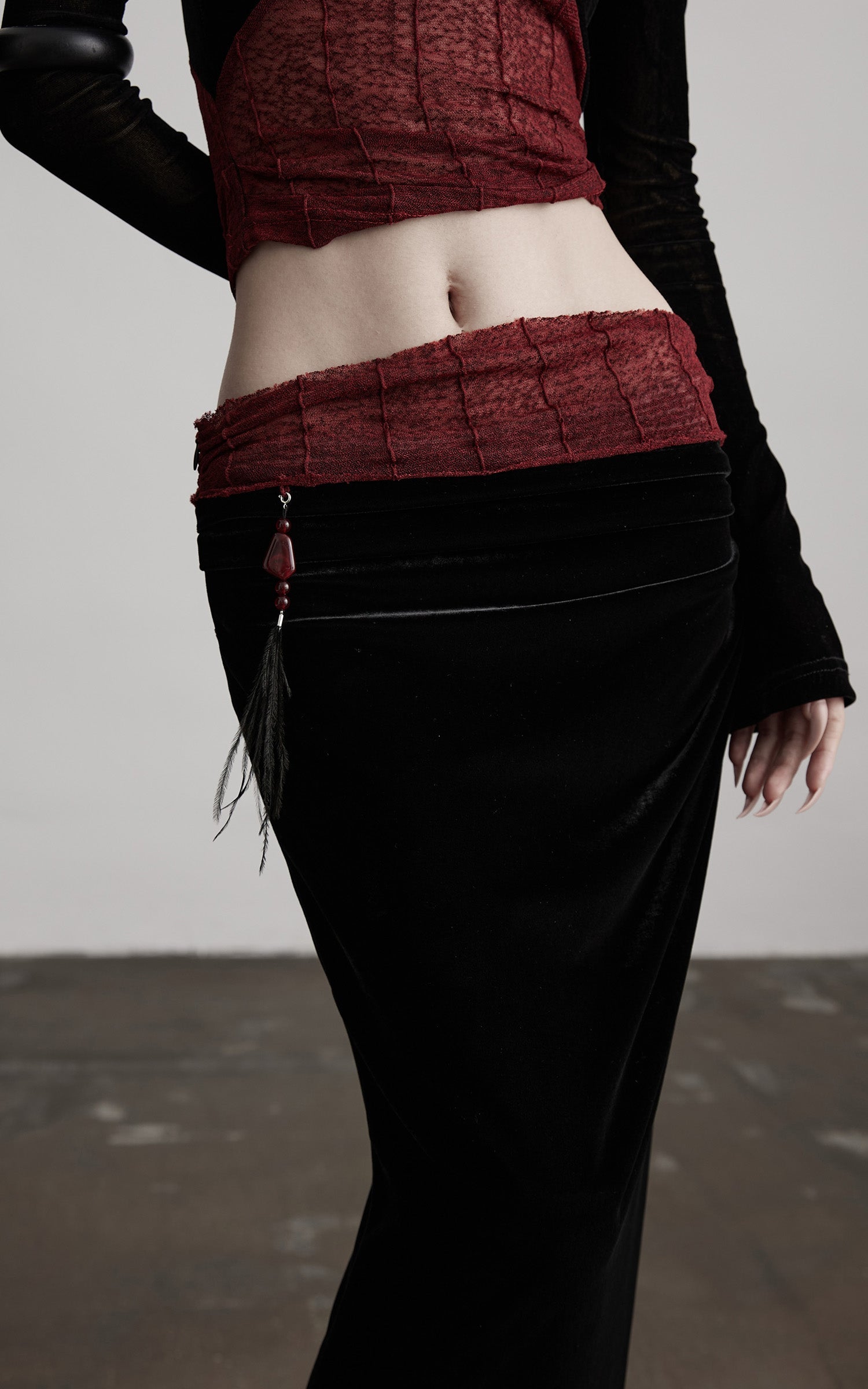 DOINDULGE Draped Velvet Skirt with Sheer Red Waist Detail