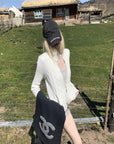 Rase le sol High Neck Cable Knit Cardigan with Sculpted Fit and Cross Zipper Detail