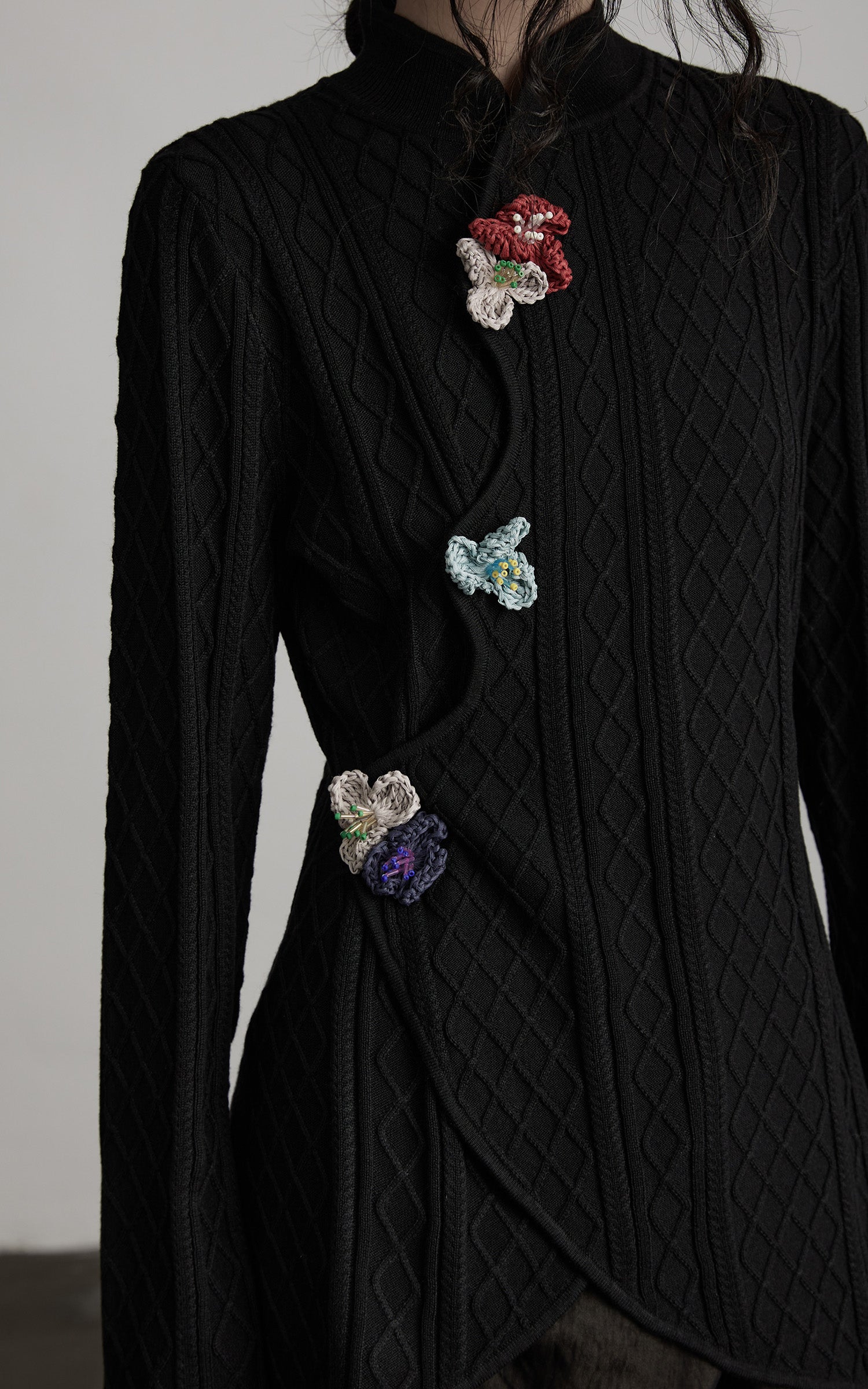 DOINDULGE Diamond Knit Asymmetric Top with Crochet Floral Details