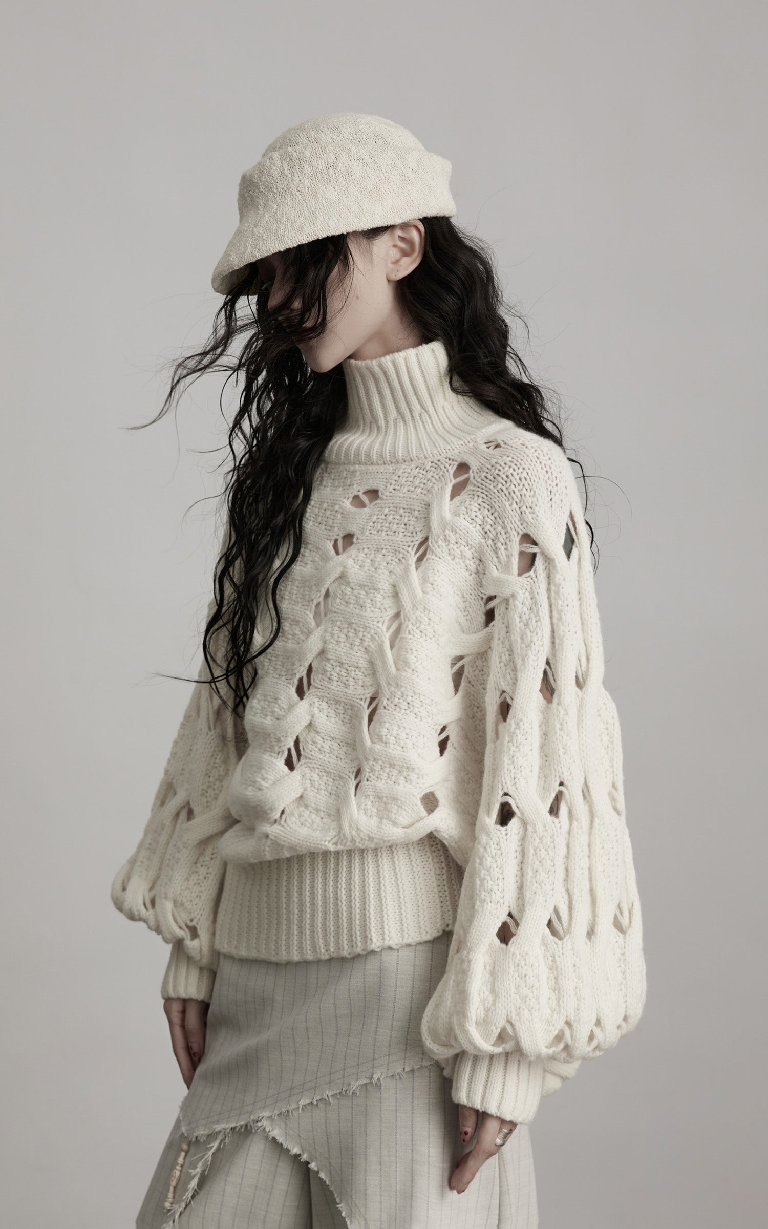 DOINDULGE Braided Void Turtleneck Sweater