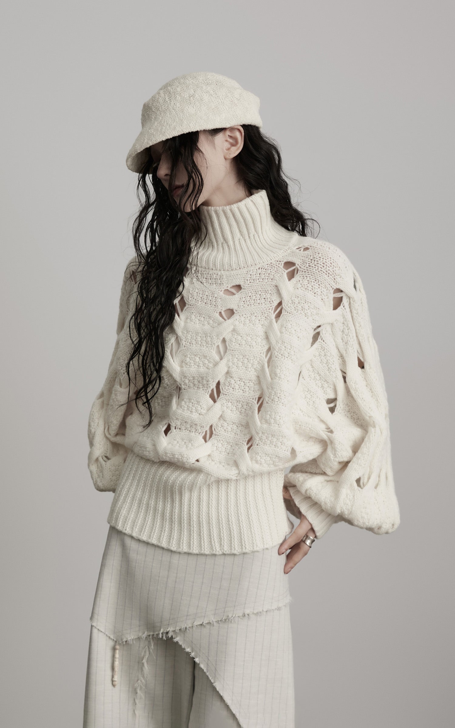 DOINDULGE Braided Void Turtleneck Sweater