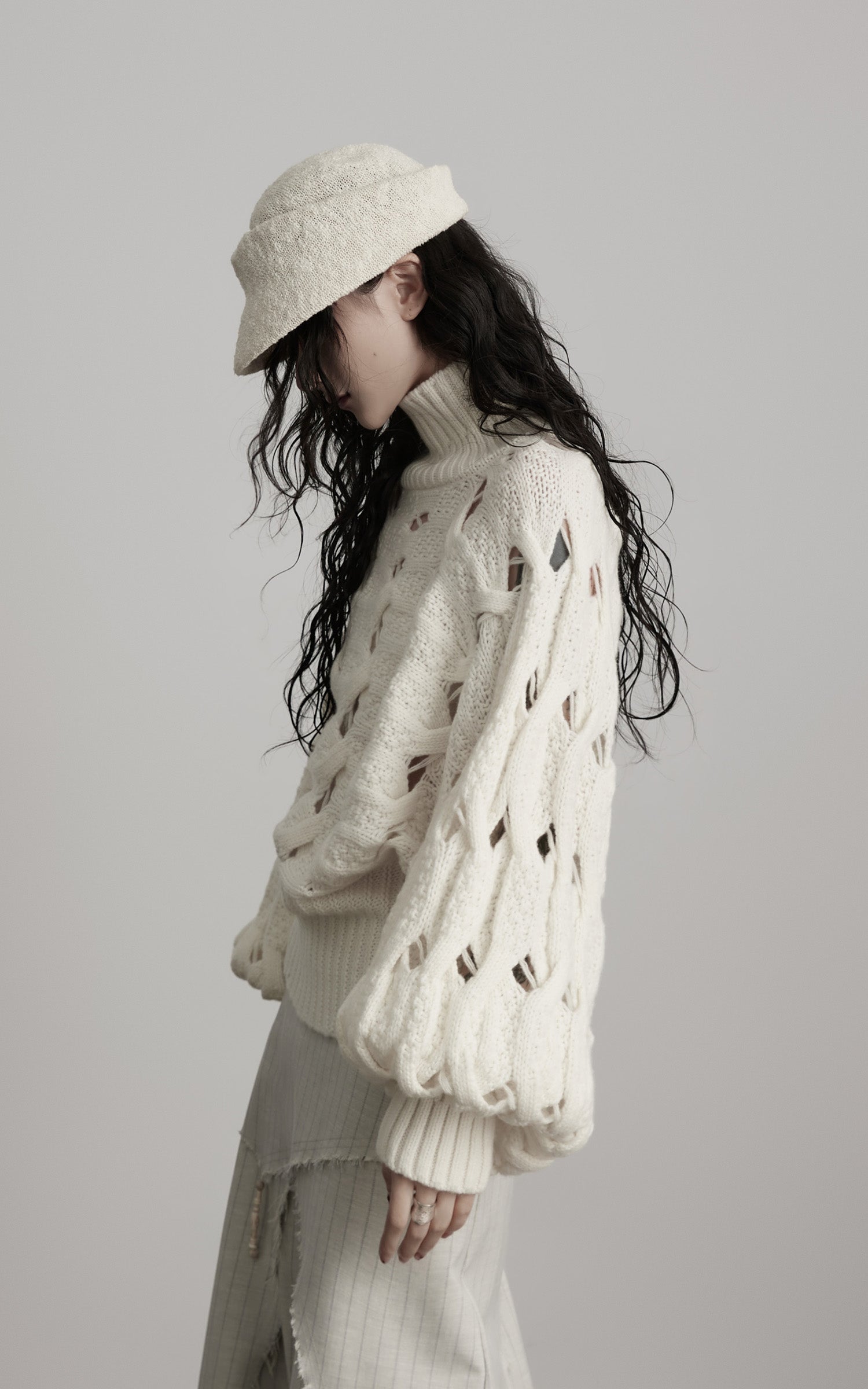 DOINDULGE Braided Void Turtleneck Sweater