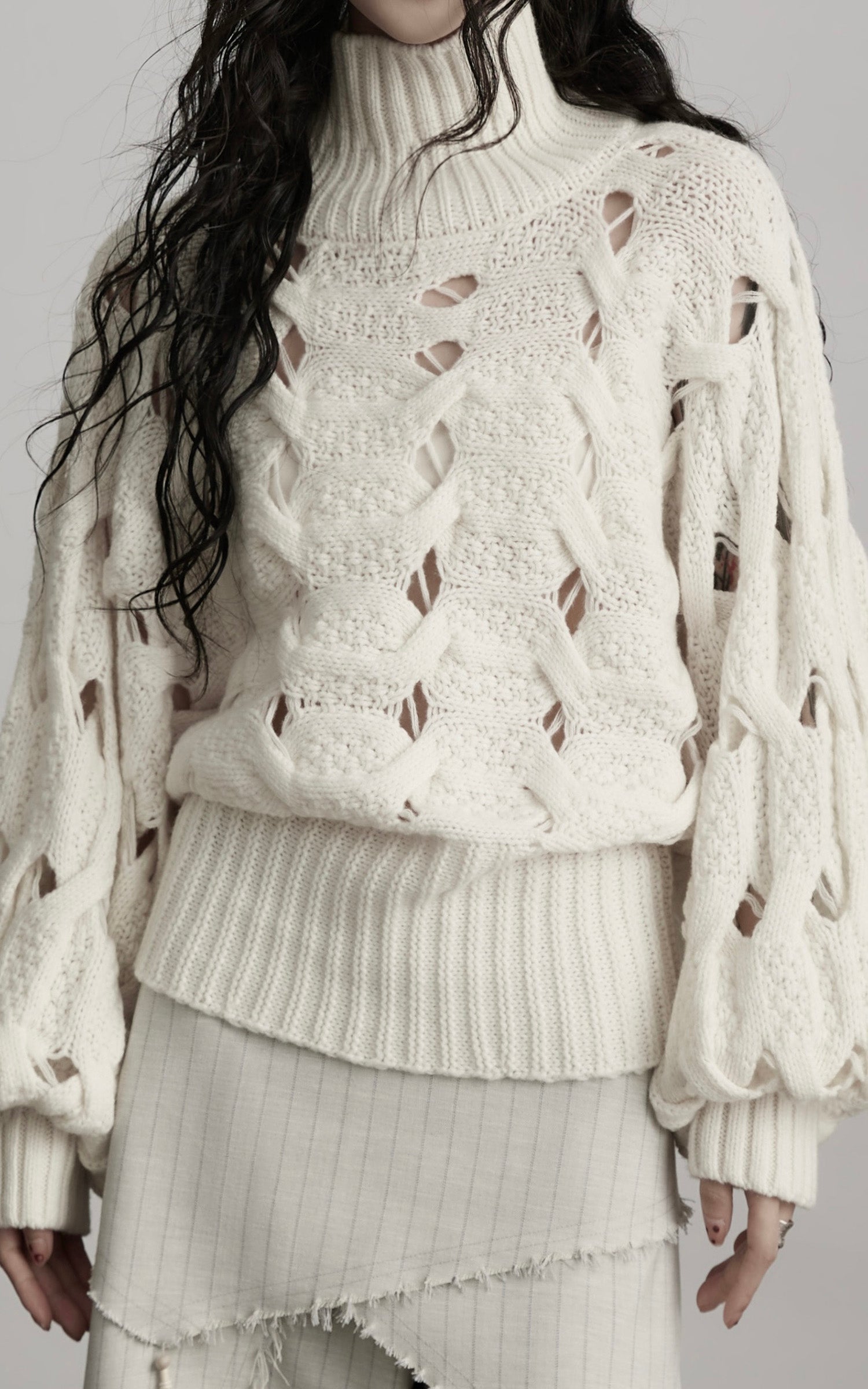 DOINDULGE Braided Void Turtleneck Sweater