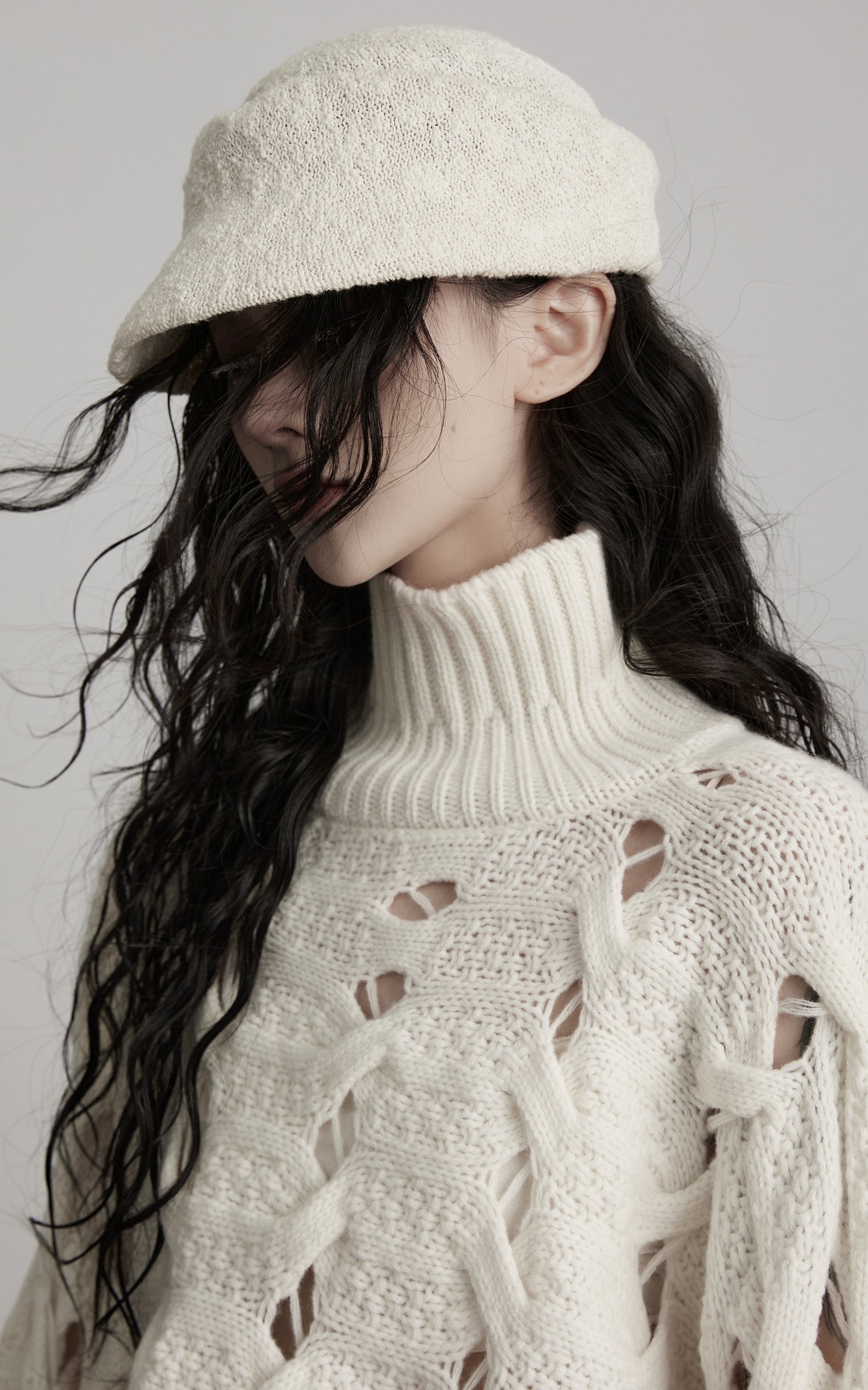 DOINDULGE Braided Void Turtleneck Sweater