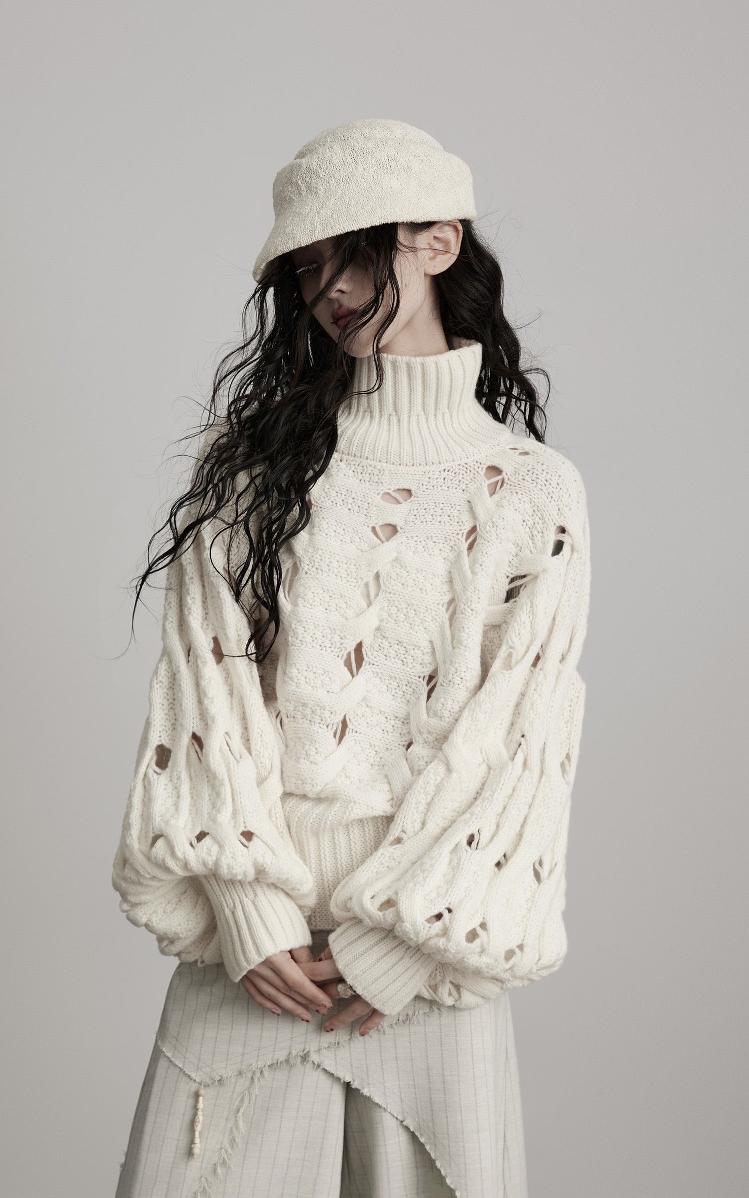 DOINDULGE Braided Void Turtleneck Sweater