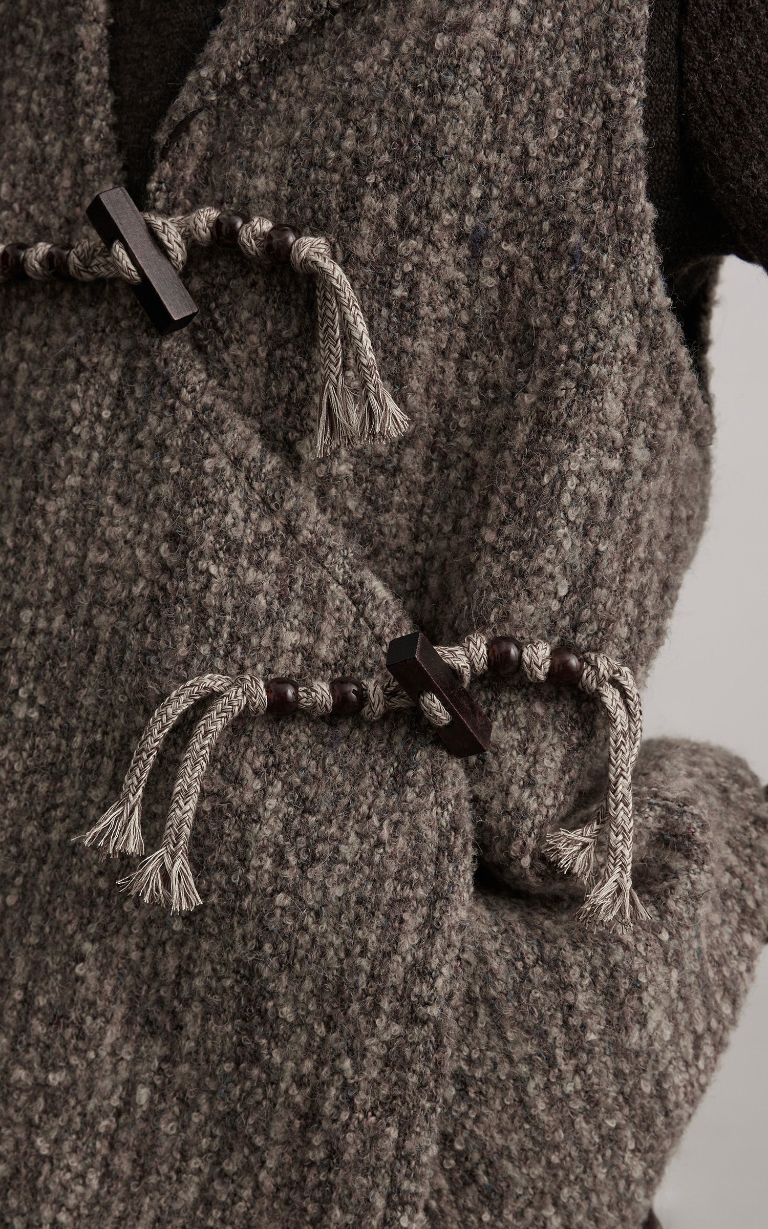 DOINDULGE Textured Wool Vest with Asymmetric Panels and Hand-Tied Toggle Details