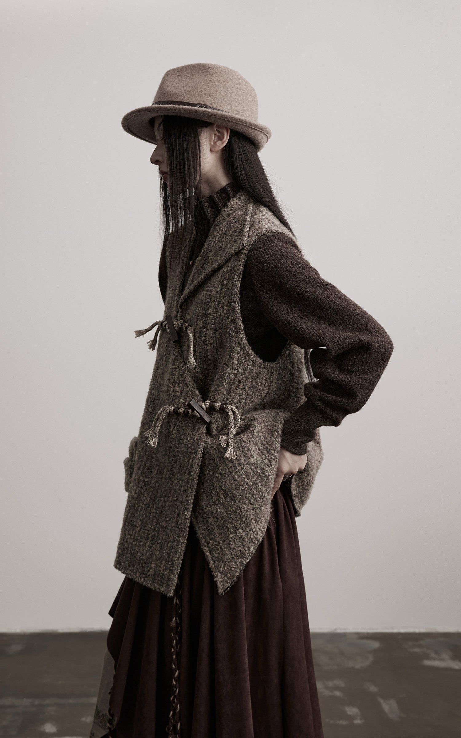 DOINDULGE Textured Wool Vest with Asymmetric Panels and Hand-Tied Toggle Details