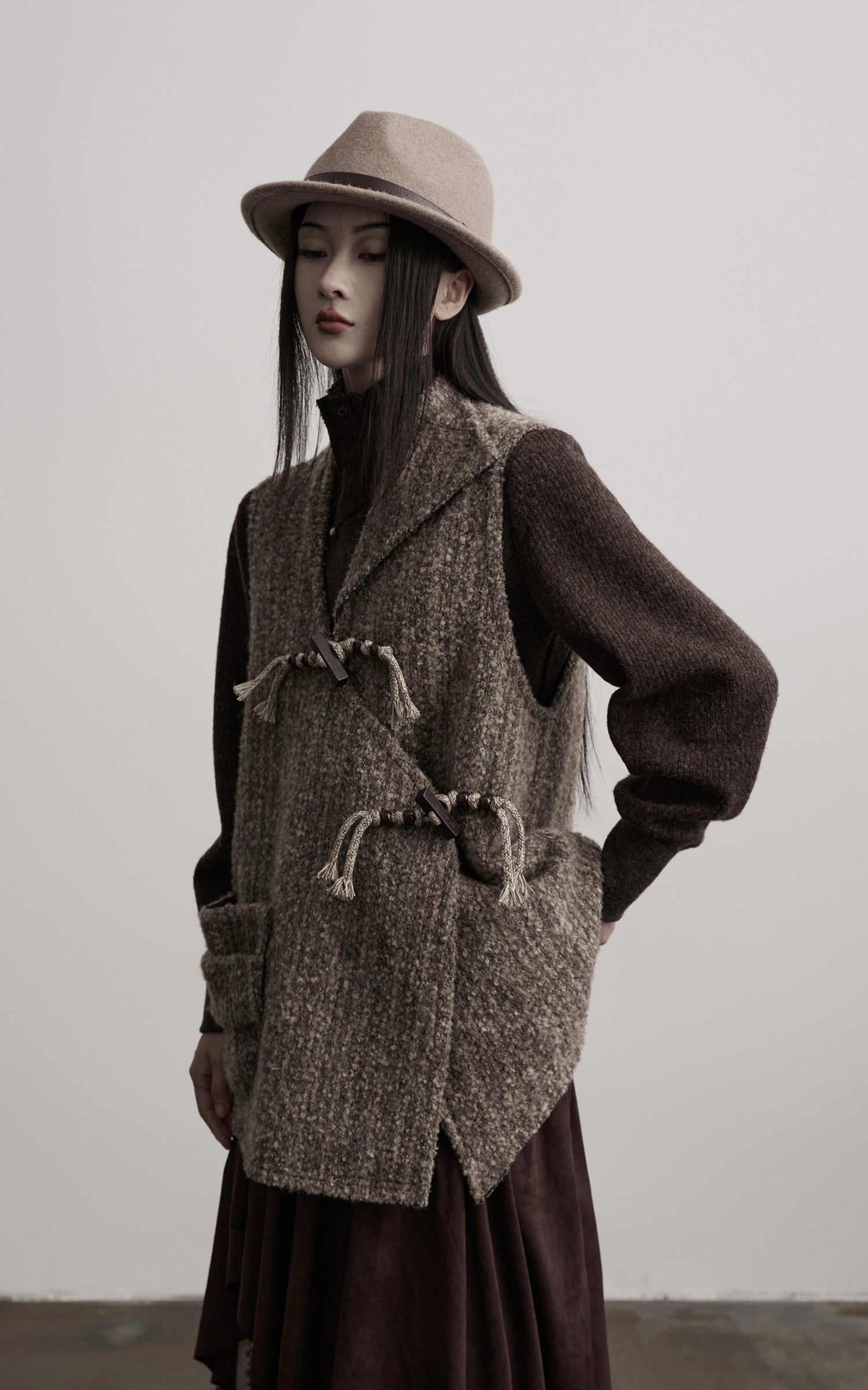 DOINDULGE Textured Wool Vest with Asymmetric Panels and Hand-Tied Toggle Details