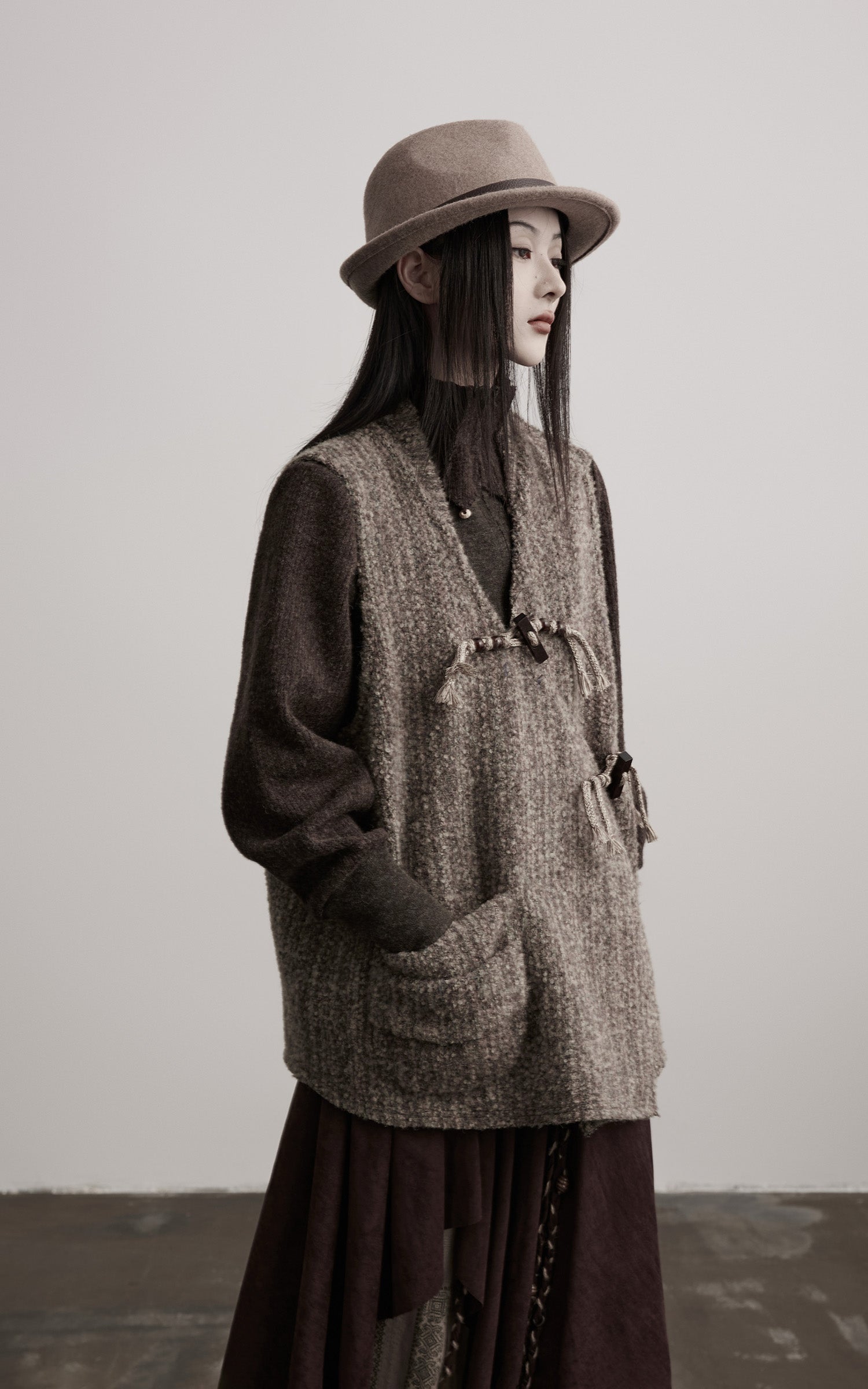DOINDULGE Textured Wool Vest with Asymmetric Panels and Hand-Tied Toggle Details