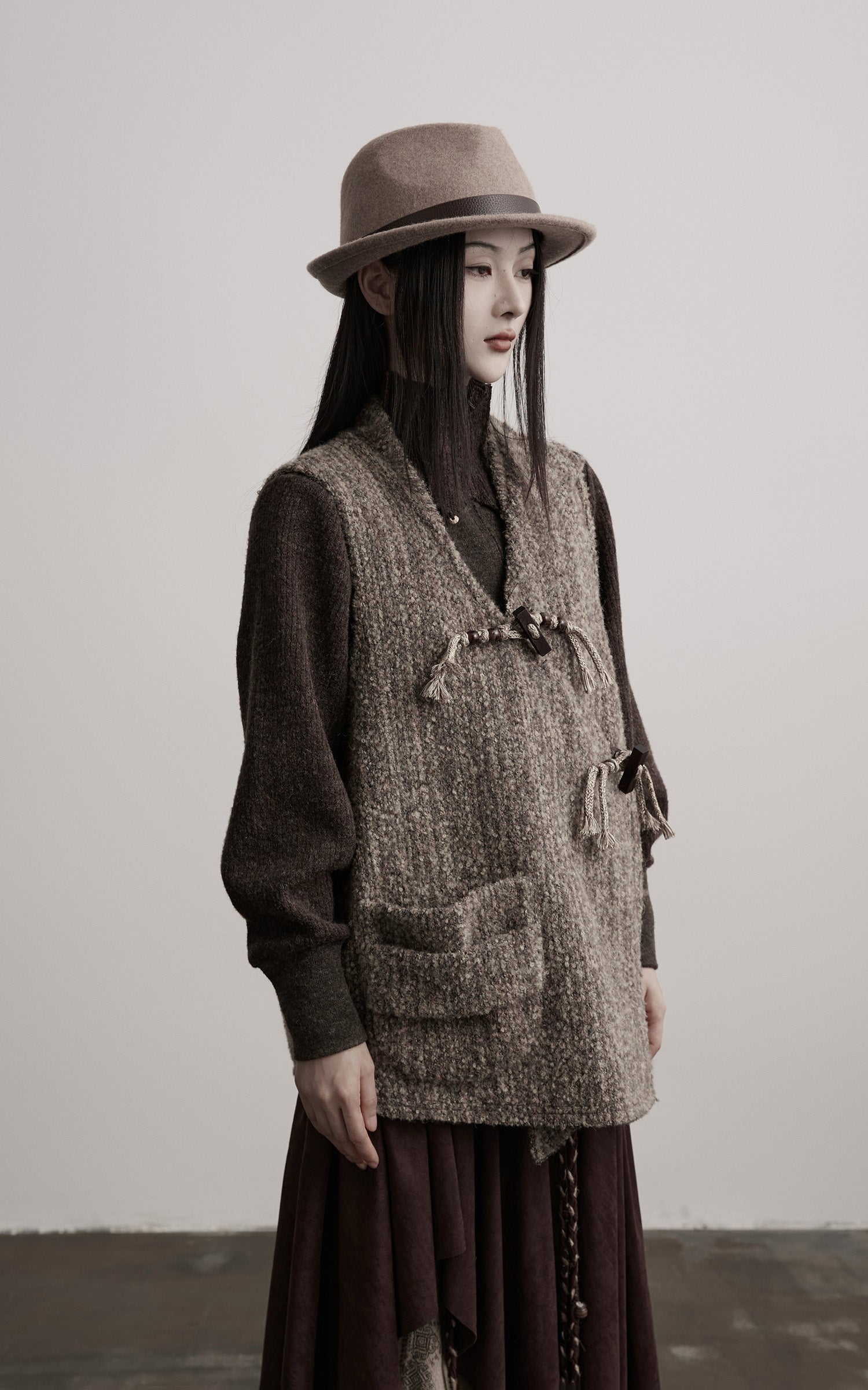 DOINDULGE Textured Wool Vest with Asymmetric Panels and Hand-Tied Toggle Details