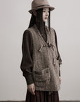 DOINDULGE Textured Wool Vest with Asymmetric Panels and Hand-Tied Toggle Details