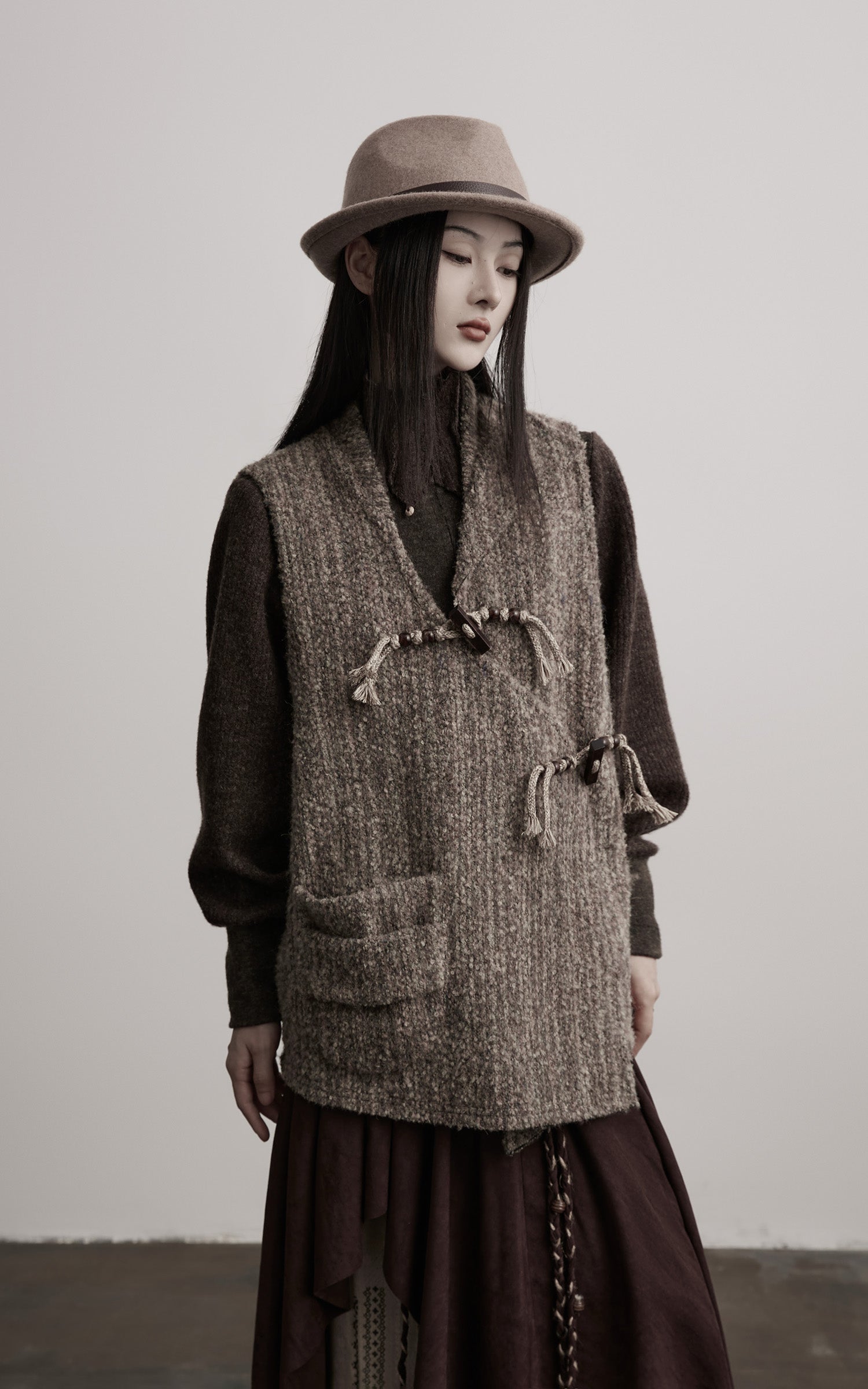DOINDULGE Textured Wool Vest with Asymmetric Panels and Hand-Tied Toggle Details