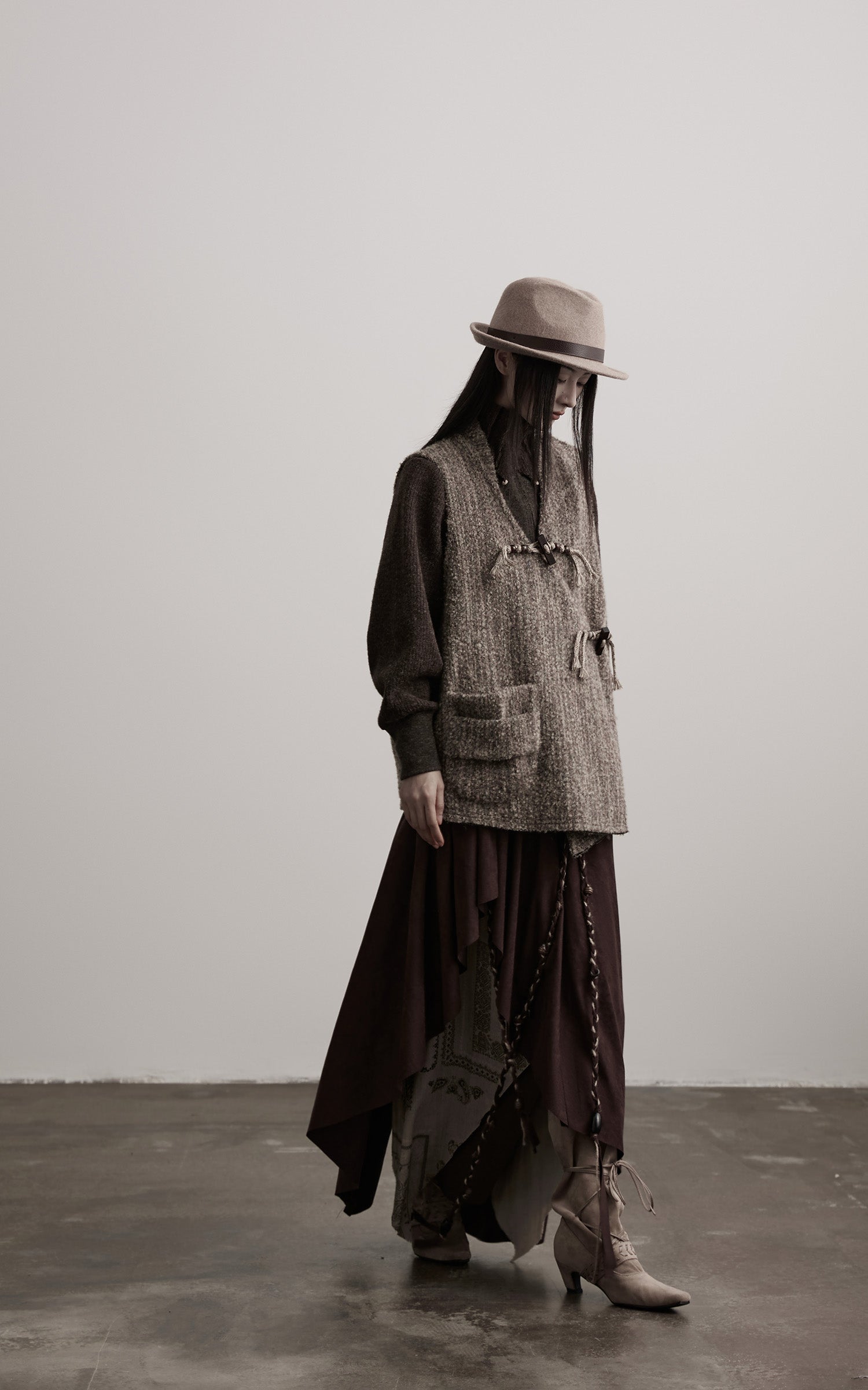 DOINDULGE Textured Wool Vest with Asymmetric Panels and Hand-Tied Toggle Details