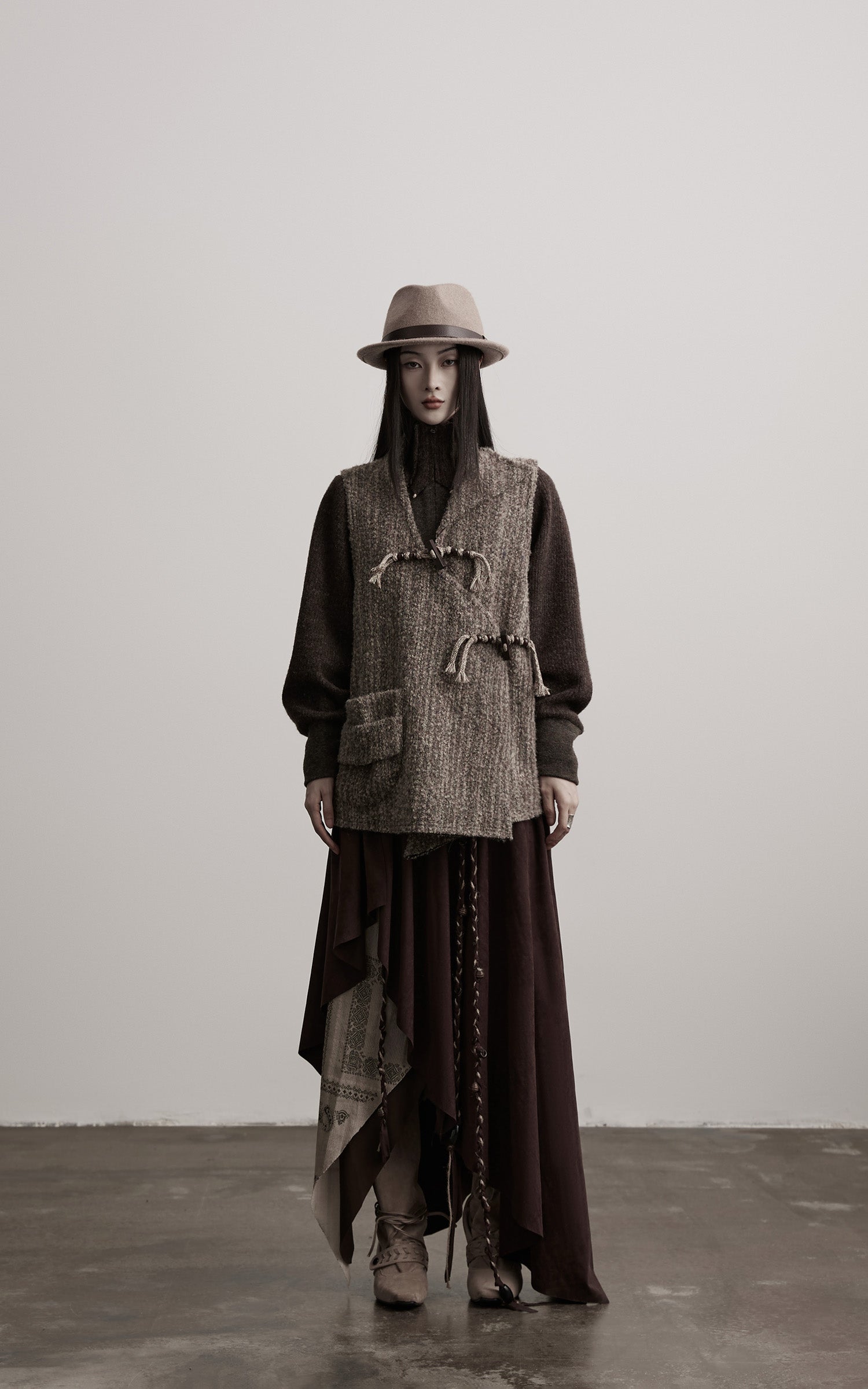 DOINDULGE Textured Wool Vest with Asymmetric Panels and Hand-Tied Toggle Details